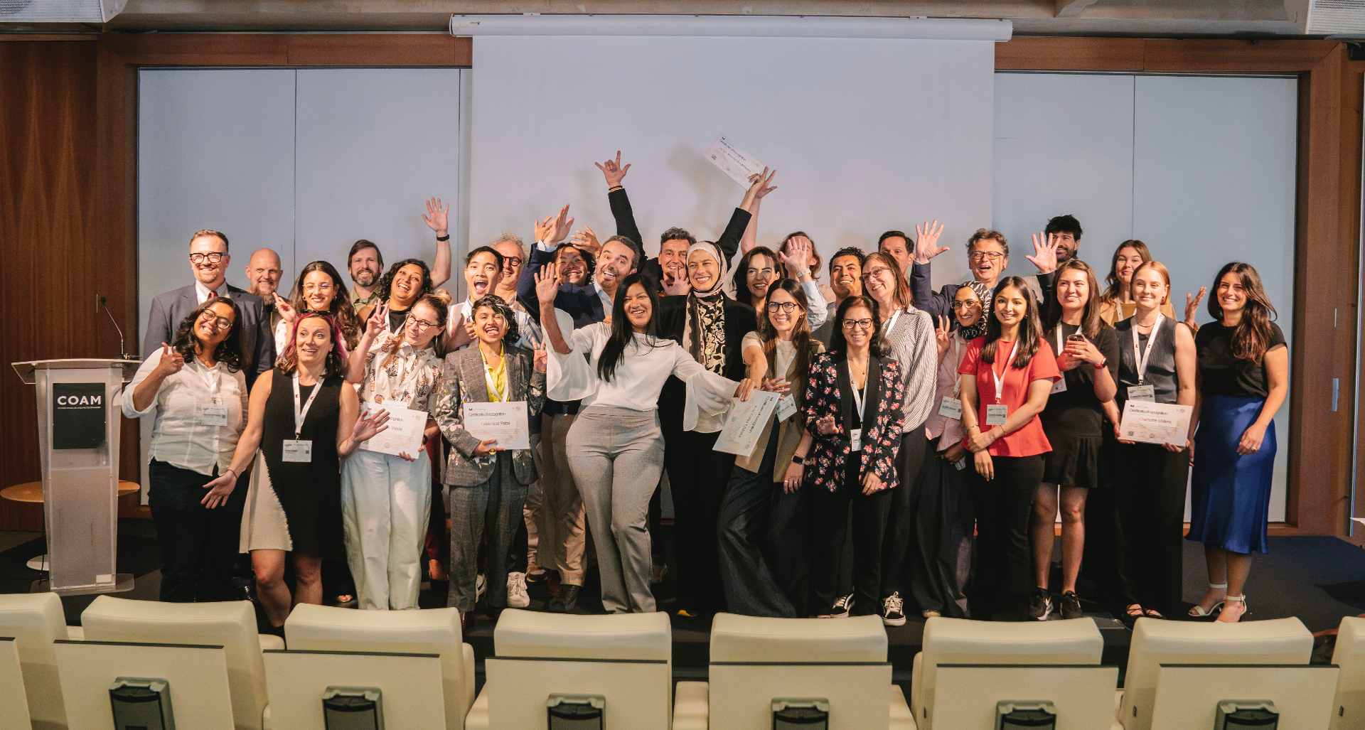 IMPUP mentees celebrating certification at COAM Madrid